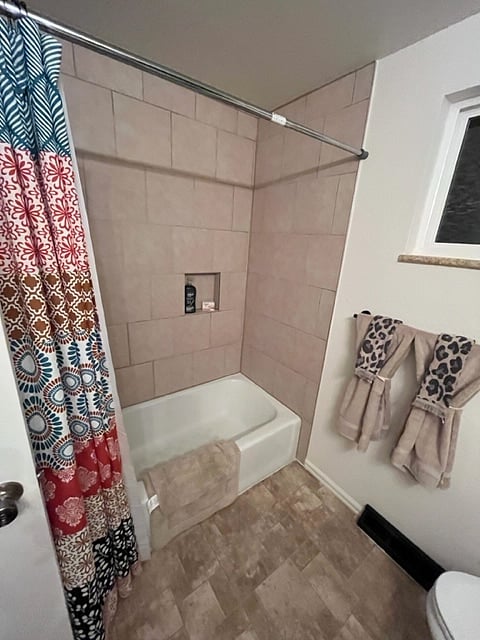 Full-size bathroom with full tub and shower