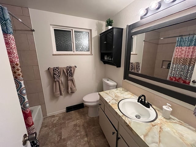 Full-size bathroom with full tub and shower