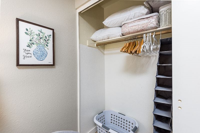 Slide closet door for area to hang clothes.