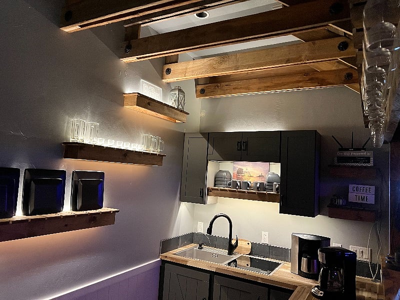 Kitchen & Bar ceiling were designed with reclaimed barn wood rafters & Metal Roof to match the Outhouse just outside.