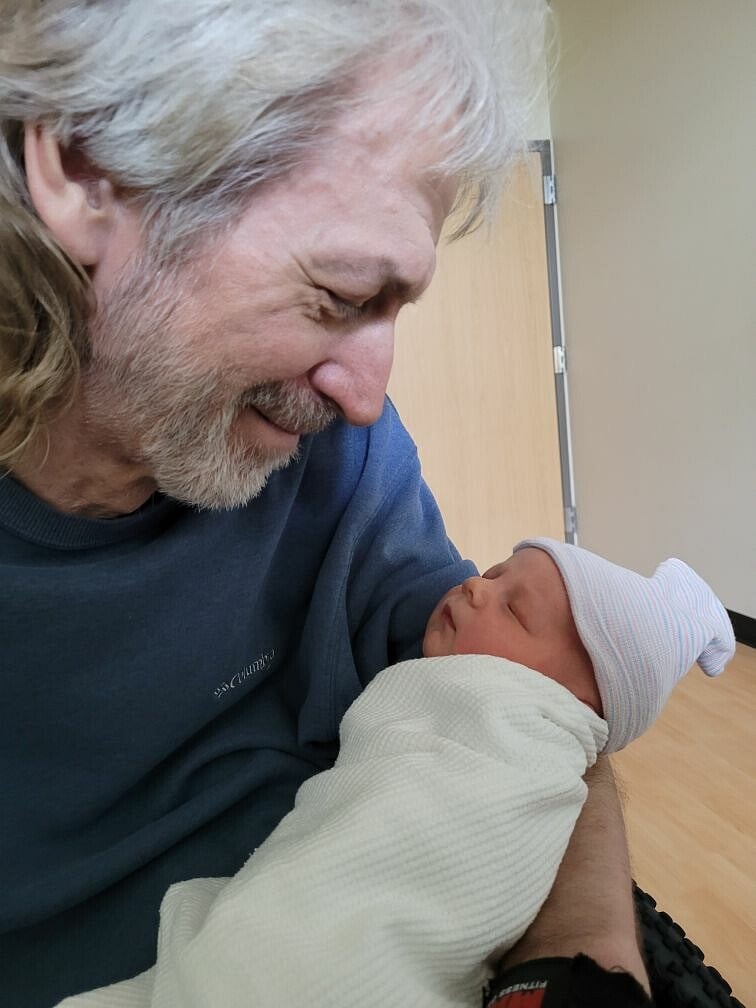 A shot of me holding my 1-day-old grandson in my lap in my wheelchair...proud Papa Dave!