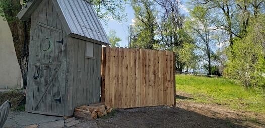 Is it a Storage Shed disguised as an Outhouse, or is it an Outhouse used as a Storage Shed...?!