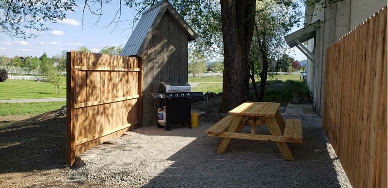 Picnic Table & Bar-be-cue Area is private & shaded, while preserving the view of the lawn & white fences.