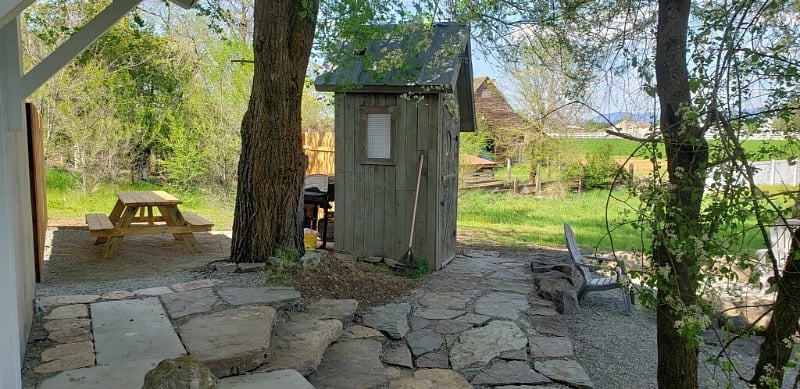 Stone Path next to Fire Pit  looks out across the grass to the Hallmark Red Barn next door.