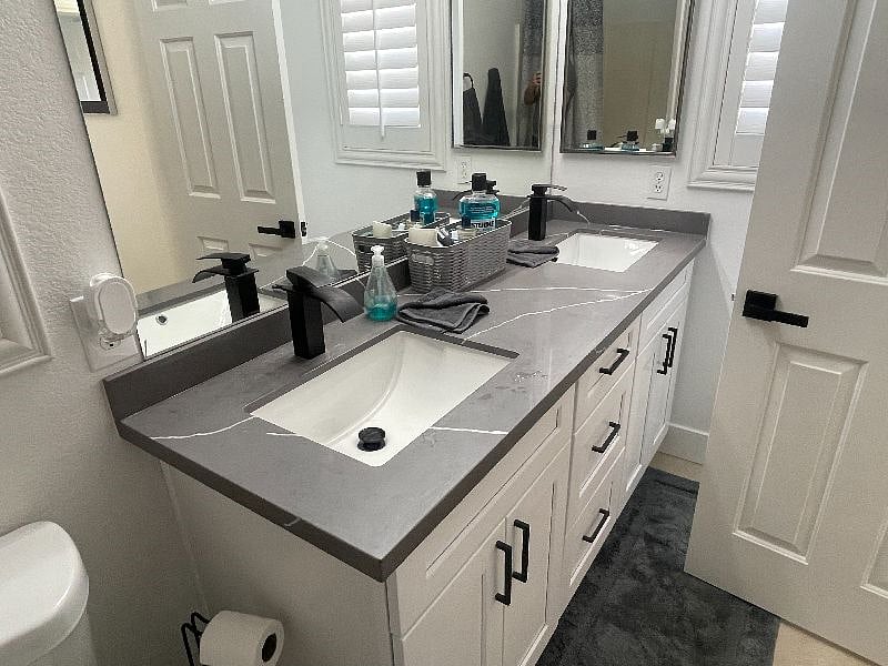The shared bathroom for the two bedrooms is very roomy w/ dual sinks