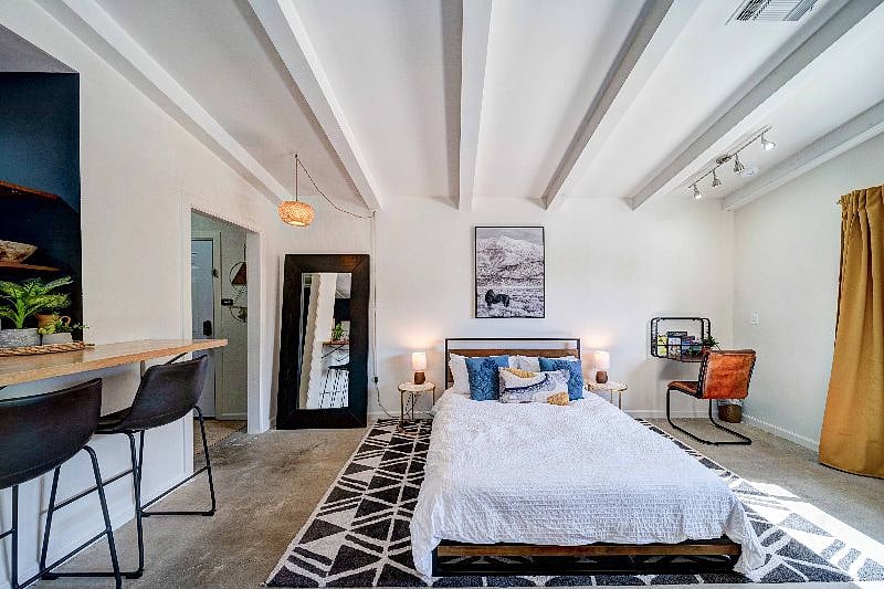 The queen bed is cozy and easily allows you to watch TV from the living space.