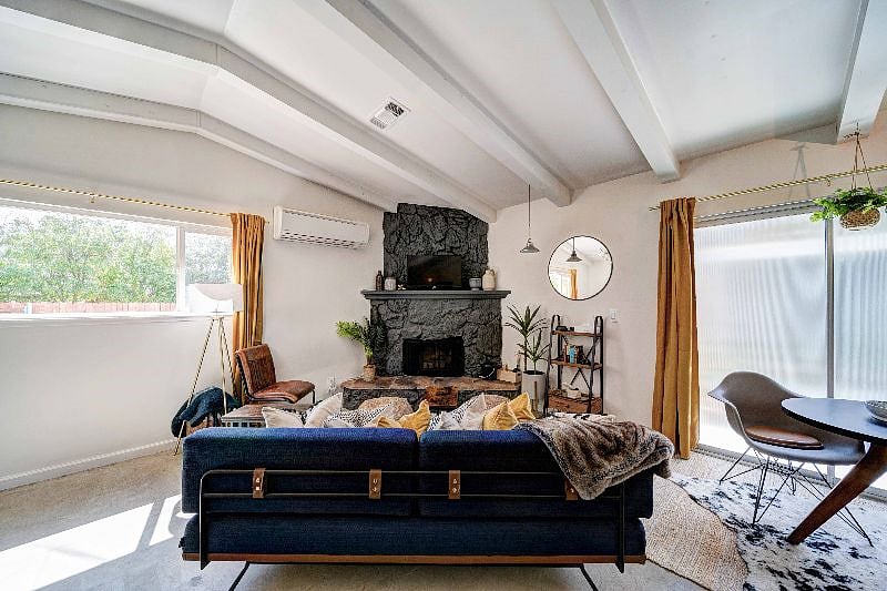The cozy living room has a Smart TV and soft to enjoy the fireplace. We provide a firestarter log for your stay and it is mostly for ambiance and we ask that you don't start wood fires in the fireplace.