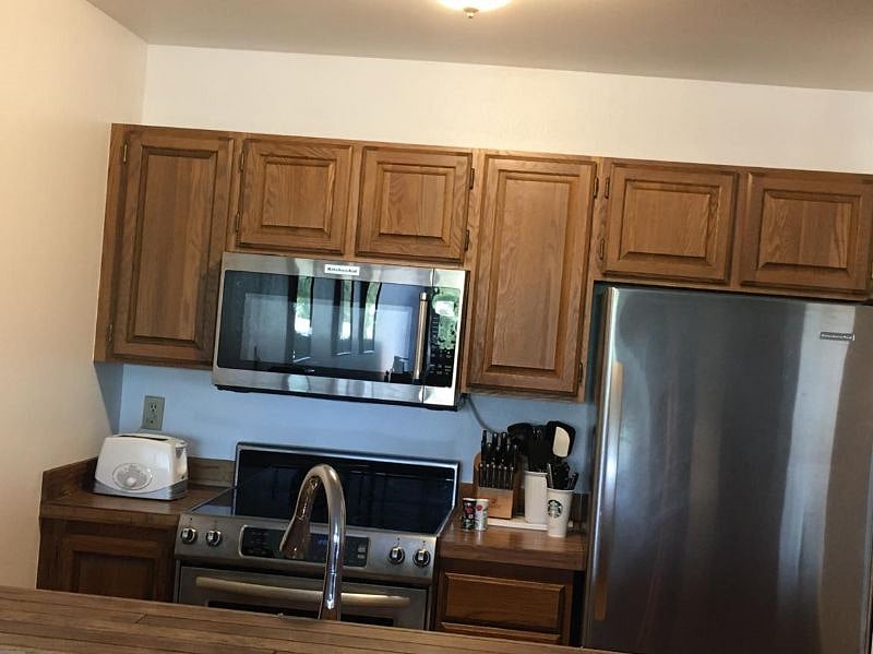 View into kitchen with full size appliances