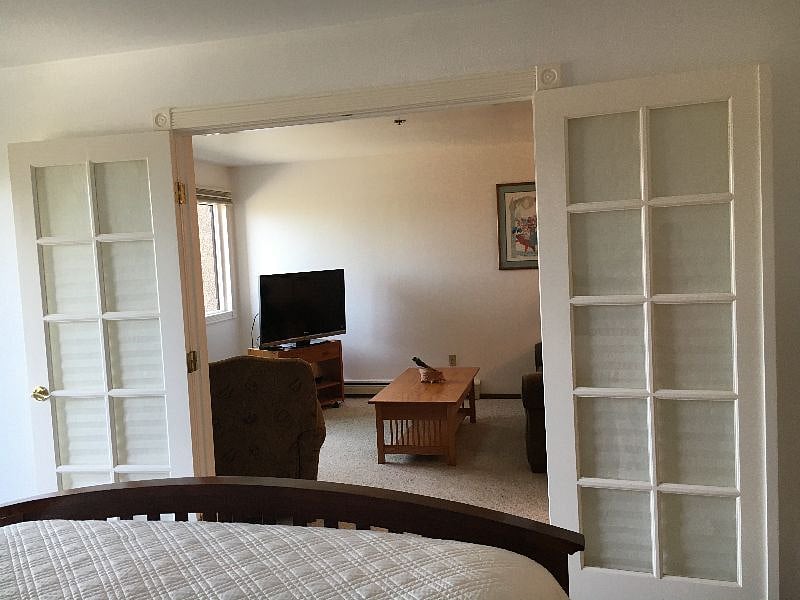 Looking into living room from bdrm with french doors open