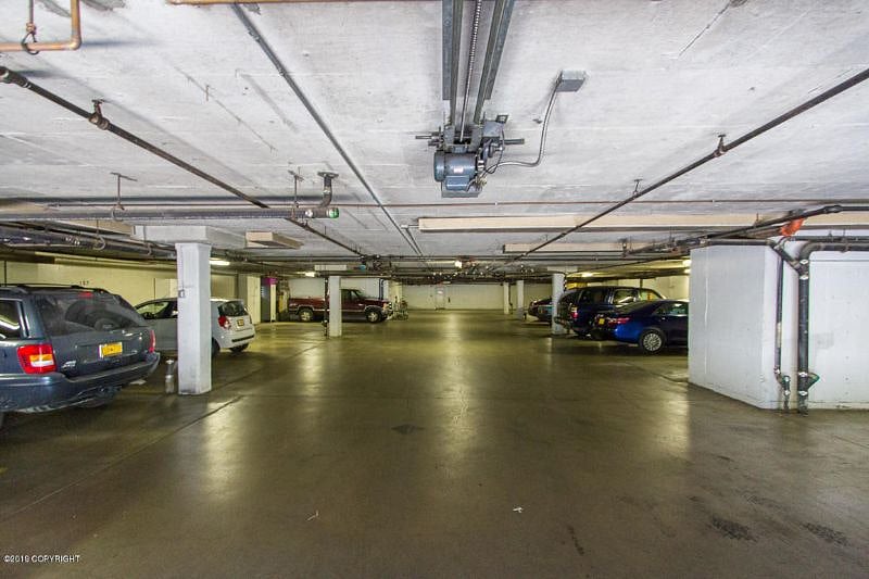 Indoor parking garage with reserved space, has storage area