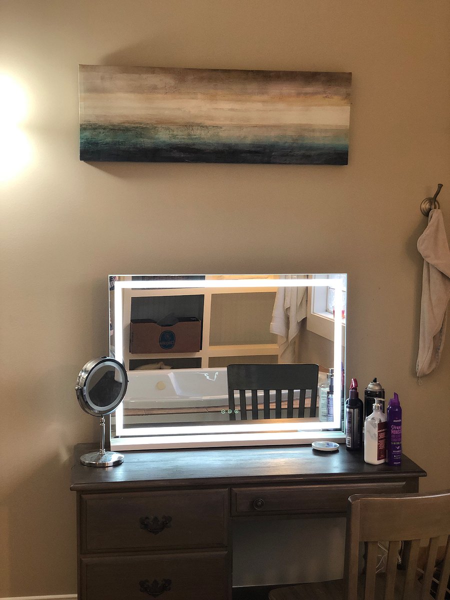 Lighted makeup mirror with a sitdown vanity