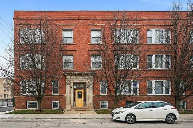 Exterior view of building, ample parking spaces on both sides of the street.