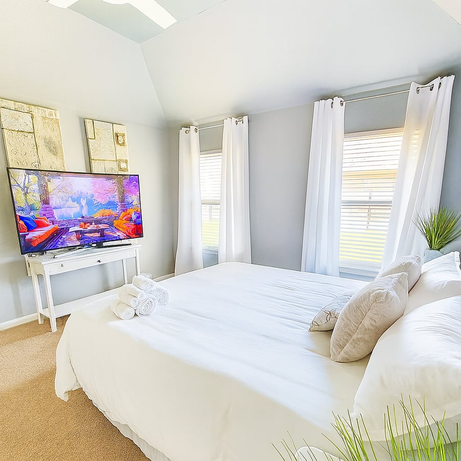 Relax in the Main Bedroom with 65 inch Smart TV. King bed. Also has  private bathroom.