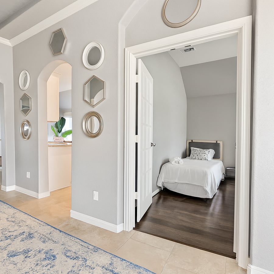 Room with single bed, workstation and closet.