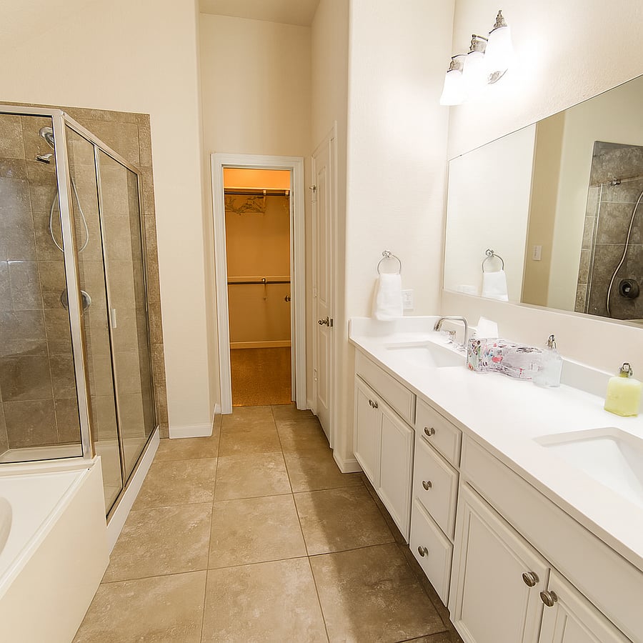 Private attached bathroom to Main Bedroom. Has a full tub, double vanities, shower, walk in closet and private toilet.