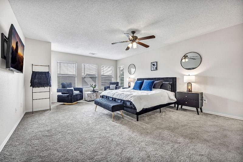 Master bedroom features a king bed with gel memory foam mattress and pillows. Seating area is perfect for a coffee corner or reading nook space.
