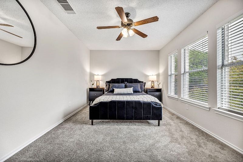 Velvet platform bed and double night stands with USB charging station lamps in the second bedroom.