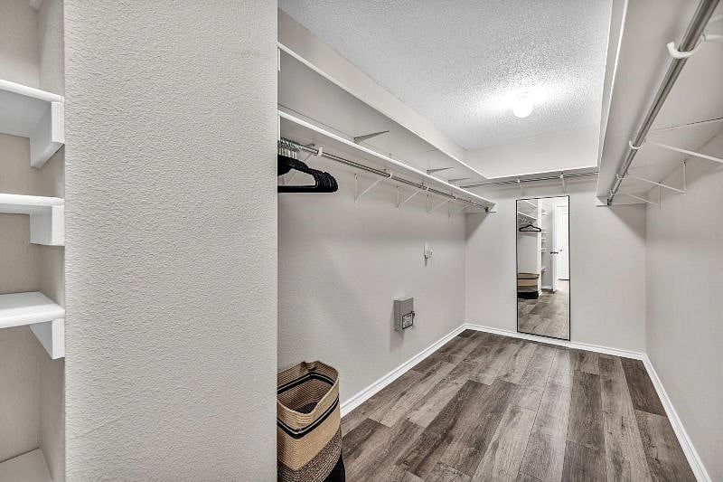 Huge walk-in closet is attached to the master suite (over 15 feet long). Hangers and laundry basket provided. Tall full body mirror completes the space.