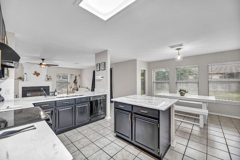 Kitchen complete with its own dining area with backyard view.