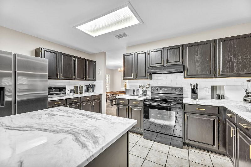 Stainless steel Samsung refrigerator with french doors features large freezer and filtered ice/water machine.