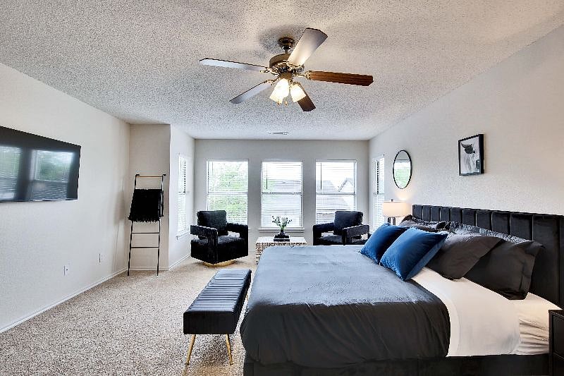 Seating area includes chenille swivel chairs and coffee table.