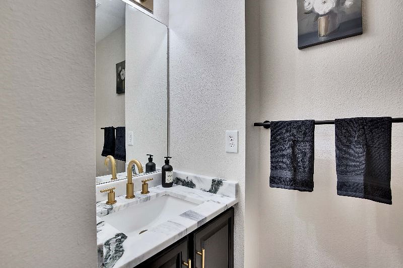 Downstairs half bathroom with vanity sink.