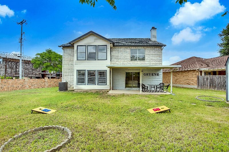 Cornhole game featured in backyard for guests.