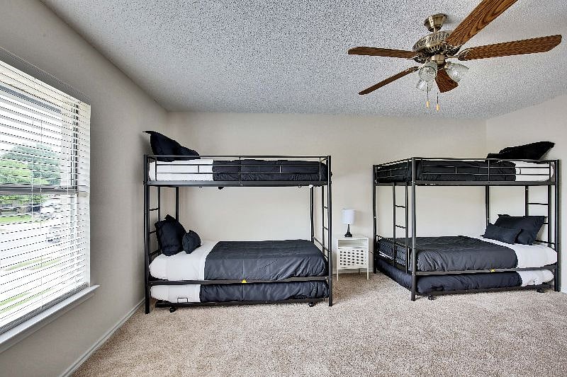 Bunk beds overlook the front of the house with a large window in the third bedroom.