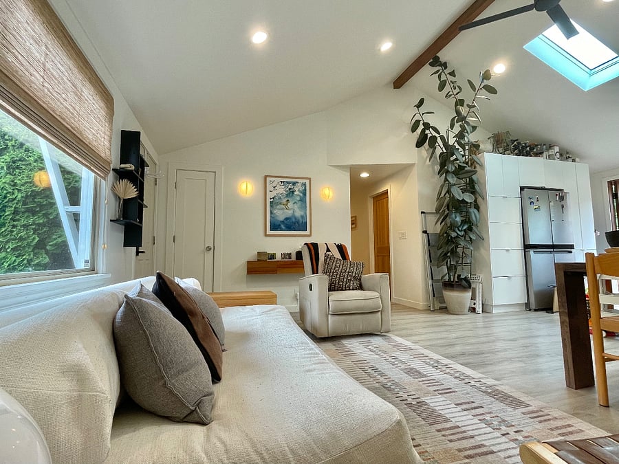 Open living space with vaulted ceiling and skylights