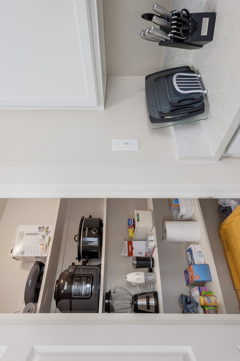 Large pantry with air fryer, crockpot, and blender.