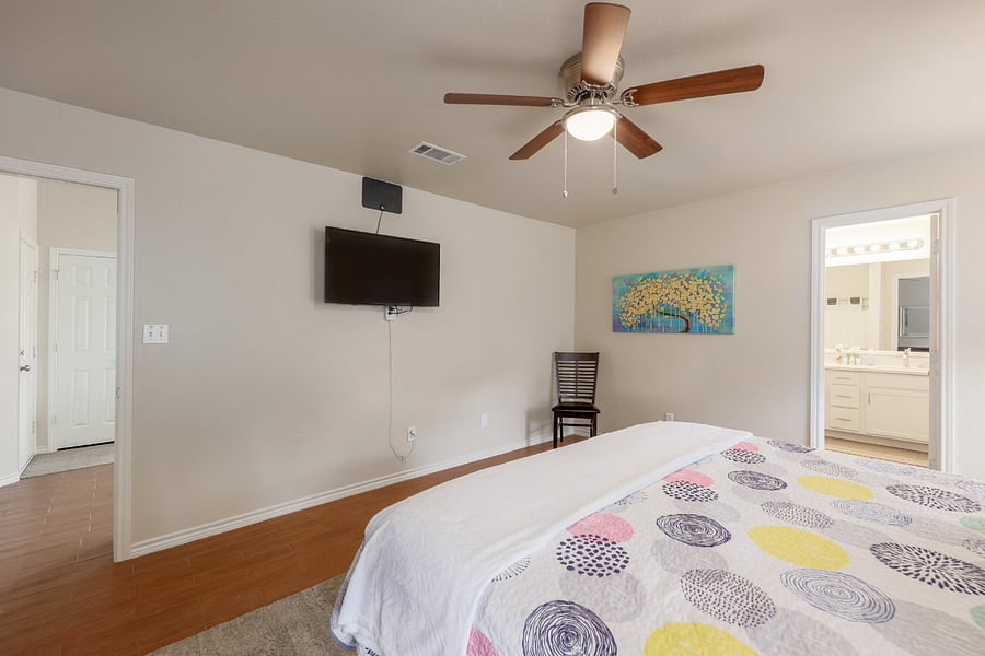 55" smart TV in primary bedroom.