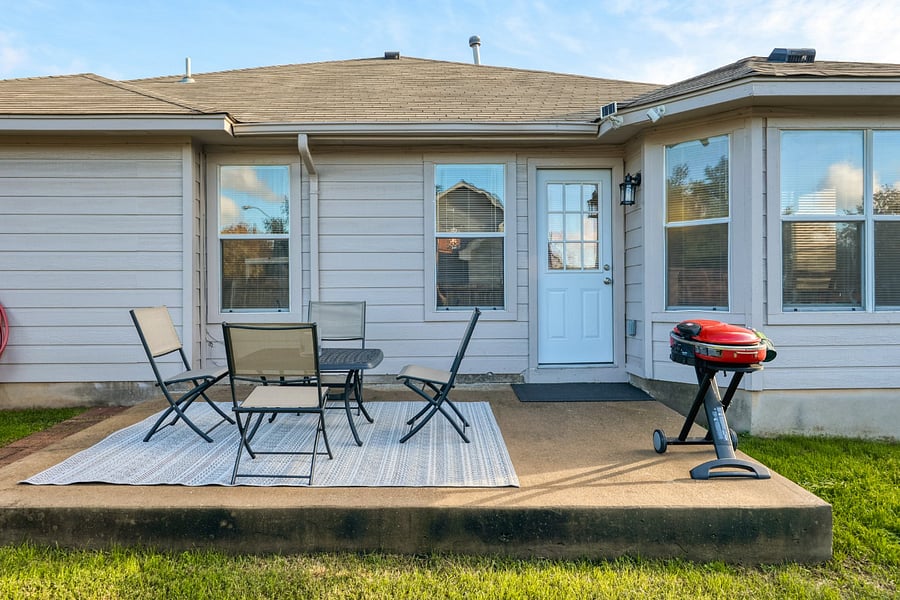 Seating area and grill in back yard.