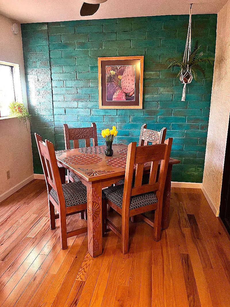 Listen to the birds as you enjoy your morning coffee in the cozy breakfast nook. Solid oak floors, shimmery copper and turquoise brick wall, beautiful hand-carved kitchen table & chairs give this space a warm and welcoming feel.