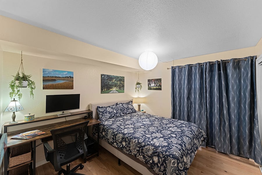 Super comfortable queen-sized bed and spacious desk. A unique feature of this room: Behind the curtains is a sliding glass door that opens into the tucked-away breakfast nook that used to be part of the backyard (hence the door) and is now usable livable space!
