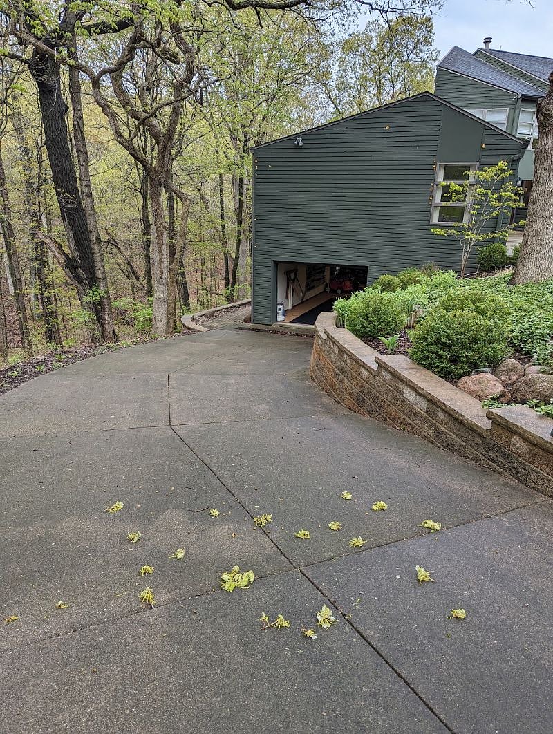 Access to garage parking down hill, as pictured.
Please note, vehicles with low ground clearance may have difficulty with entry to garage space due to hill. Parking in driveway is available as an alternate option.
