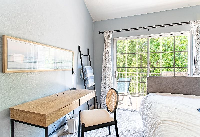 You can feel like you are staying on top of things with this spacious home office, pausing and laying down to contemplate and take in nature just beyond the sliding door and balcony