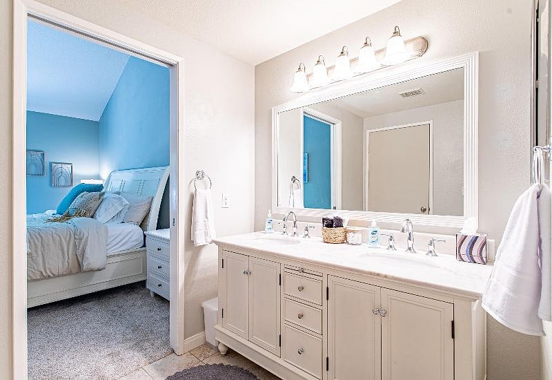 Double-sink bathroom with large, well-lit mirror enables you to look your best in your new community