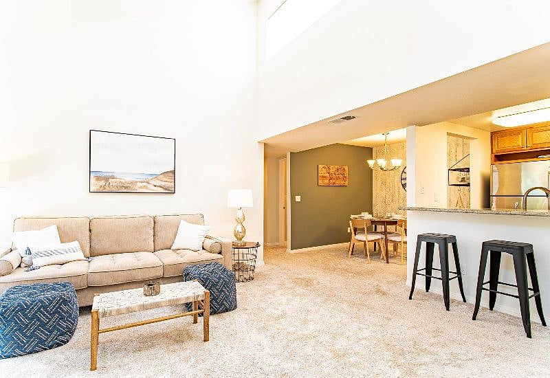 Dining table and split level kitchen countertop with bar stools provide plenty of options for places to eat at home