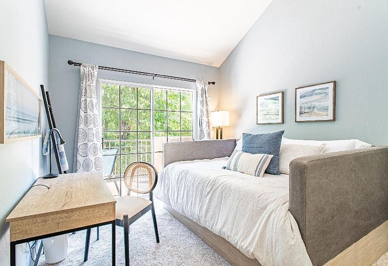 You can feel like you are staying on top of things with this spacious home office, pausing and laying down to contemplate and take in nature just beyond the sliding door and balcony