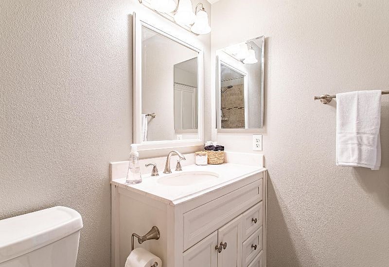 Bathroom featuring a cabinet-style vanity and fresh towels and toiletries. You have everything you need to feel fresh and clean