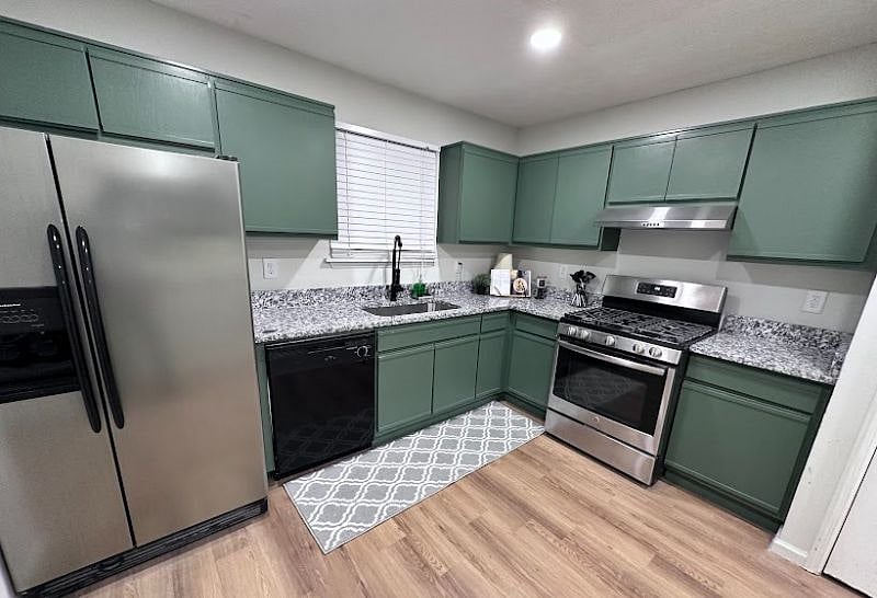 Full kitchen with side-by-side refrigerator, full stove, oven and dishwasher. Plenty of cabinet space and stocked with kitchen essentials.