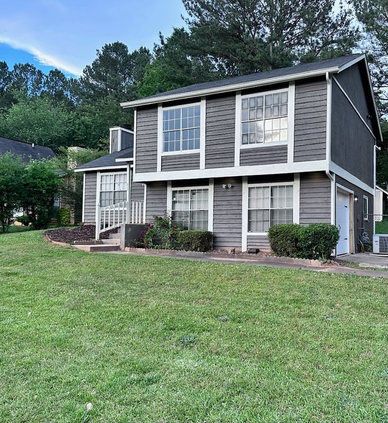 Front exterior of home with large yard on corner lot