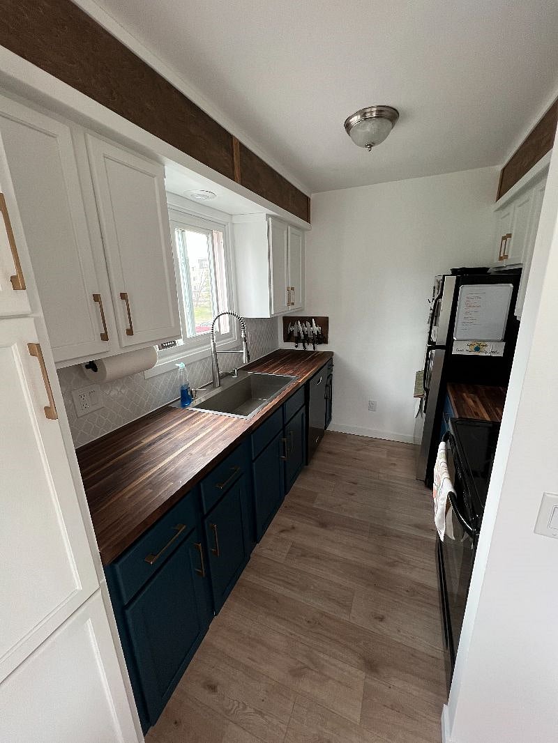 Fully renovated kitchen fall 2022, butcher block counter tops, dishwasher, full fridge and freezer, oven/stove, coffee pot.