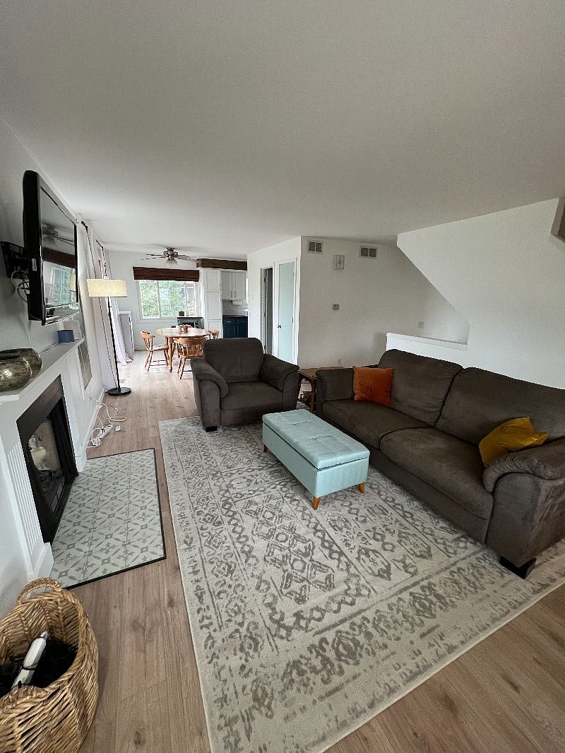 View of the living room, dining room, kitchen area.