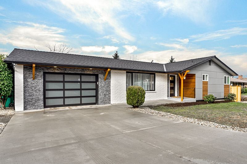 Front of house showing a one car garage and the main entrance for the Upper Unit