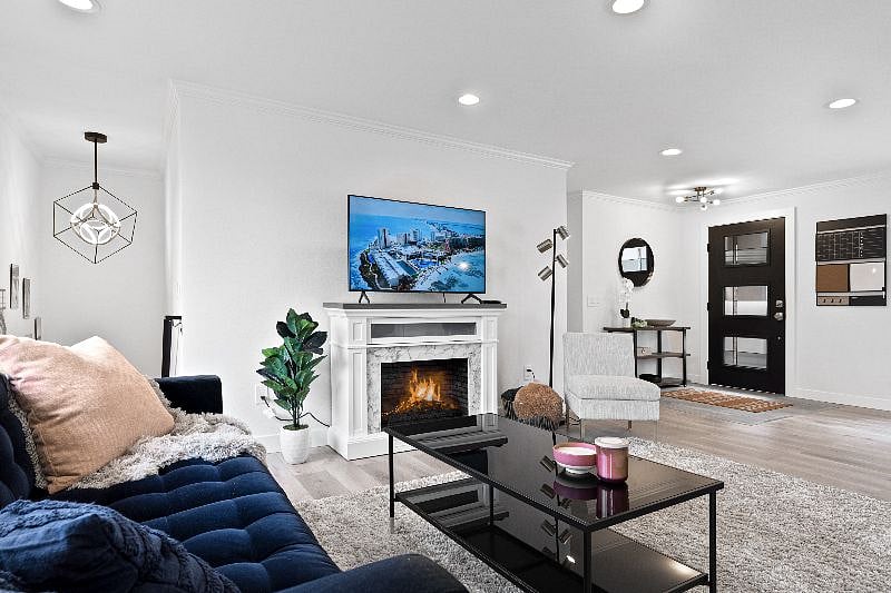 Upper Unit 2BD / 2BA:
Living Room with electric fireplace