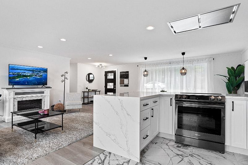 Upper Unit 2BD / 2BA: 
Kitchen with quartz countertops and SS appliances