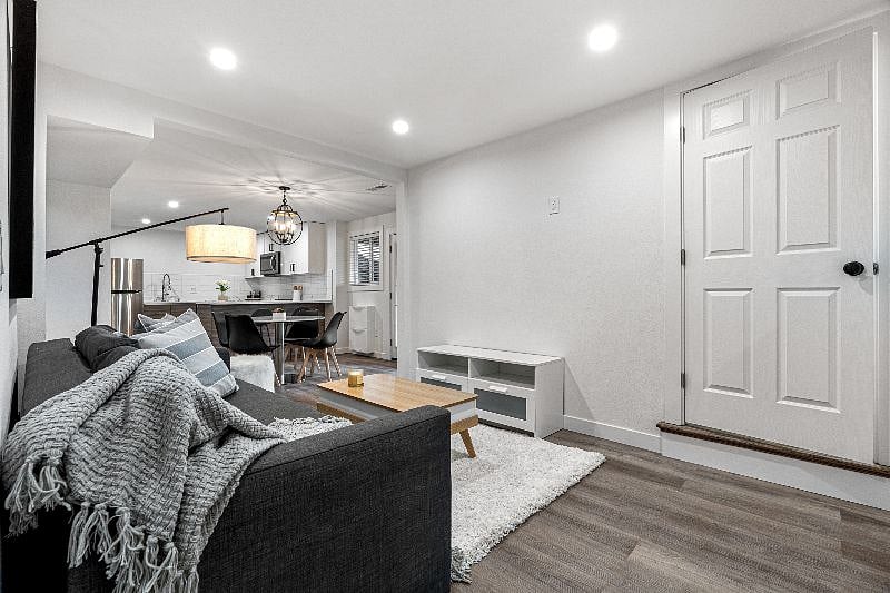 Lower Unit - 1BD/1BA/1Office:
at Living Room showing a lockable door at the base of stair that separates the Upper and Lower Units