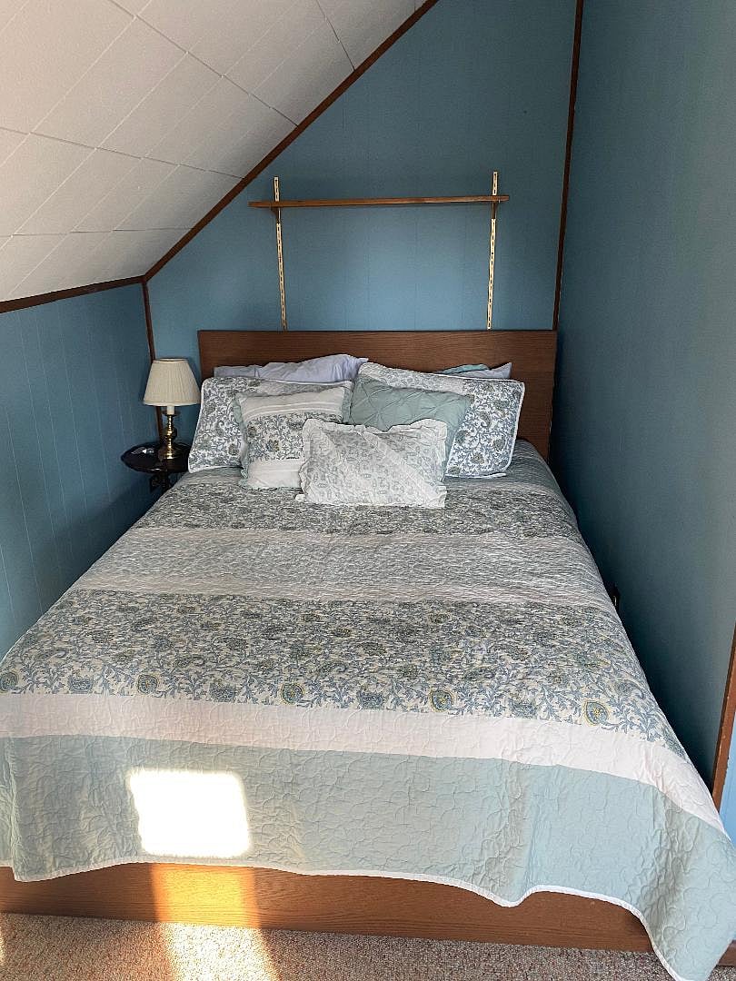 Bedroom #2 has bed, dresser, desk with office chair and loveseat in lounge area all within the room