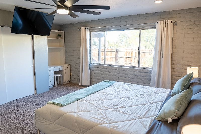Bedroom 1, including fully retractable 50" Amazon Fire Smart TV for easy access to closet and Remote Working Station